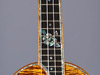 A long scale concert ukulele with 12th fret hibiscus inlay and abalone purling on the body and fretboard.